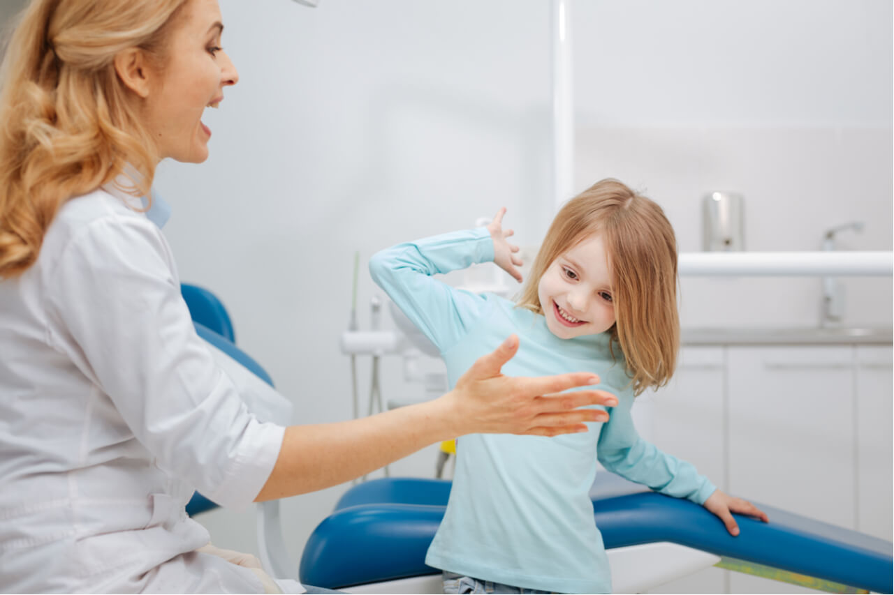 pediatric dental surgeon with kid