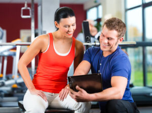 personal trainer teaching a client