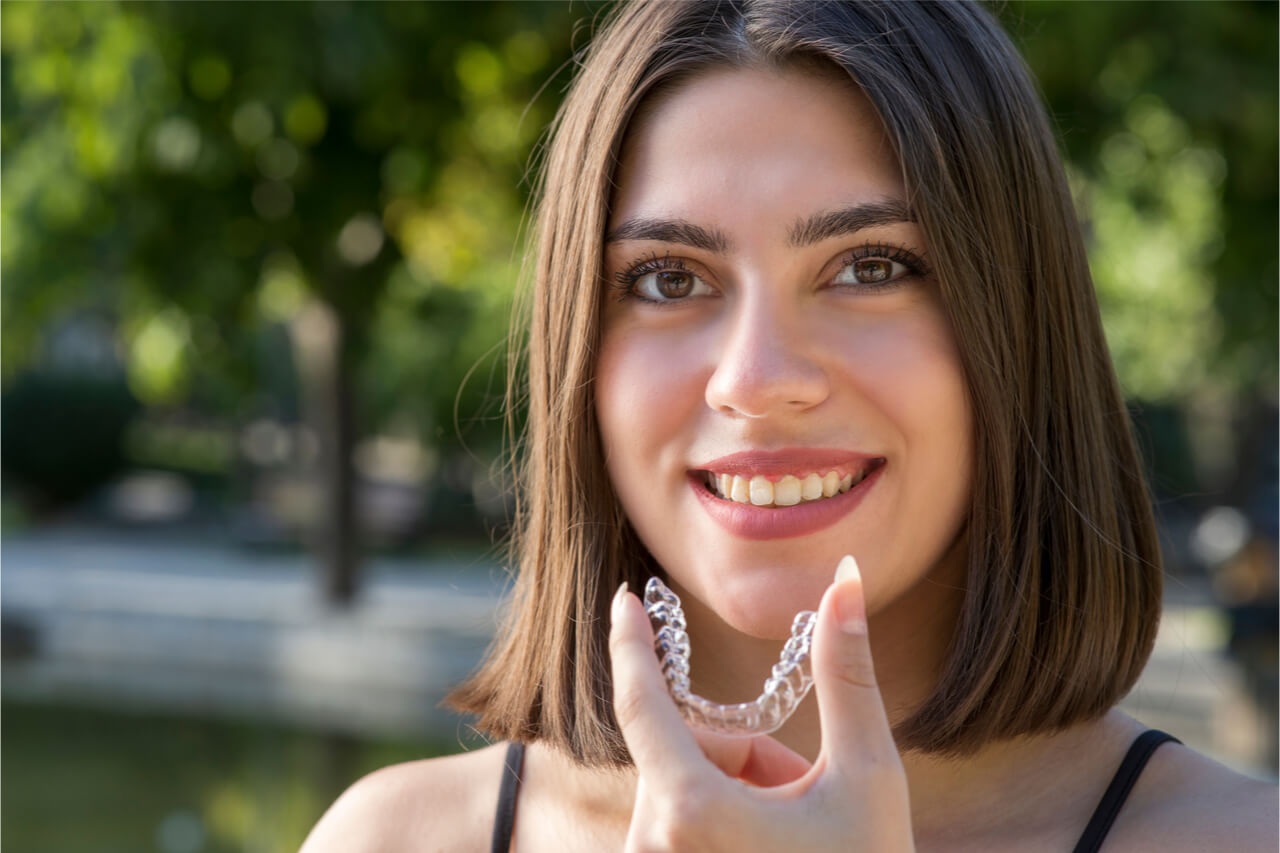 woman holding a mouthguard